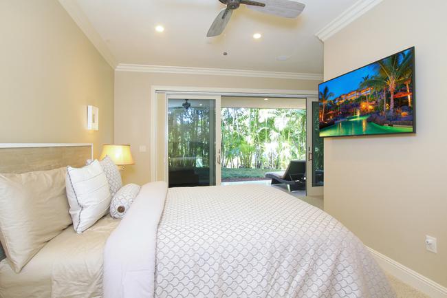 The downstairs master suite has been thoughtfully divided up into two bedrooms, this photos shows the 3rd bedroom, each with lanai access!